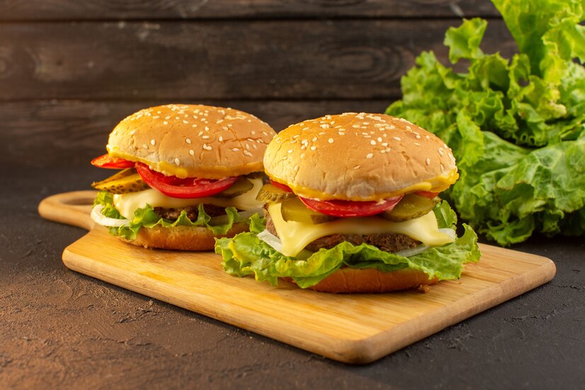 The cheeseburger is usually served on a bun with lettuce, tomato, onion