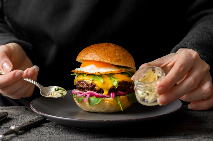 Using a spatula, carefully flip the burger patty